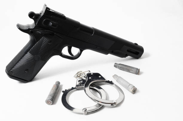 istock Pistol Gun and Handcuffs 1251492977