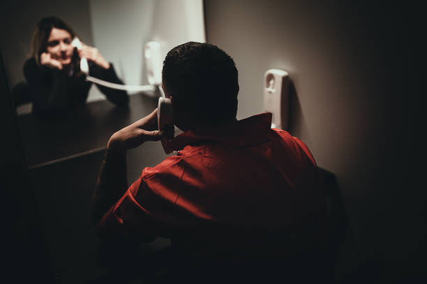 Woman and her husband sitting in prison visiting room