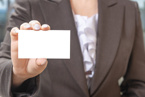 a businessman is holding a blank business card