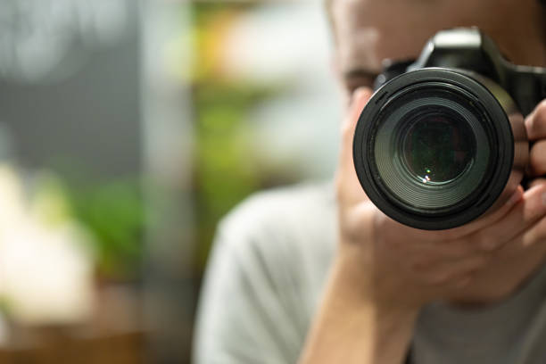 istock Reflection in the mirror of a man with a camera. 1251494340