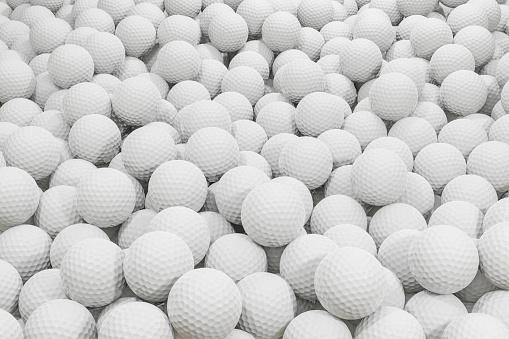 Large pile of white golf balls
