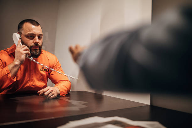 istock Male detective and prisoner sitting in visiting room 1251496186