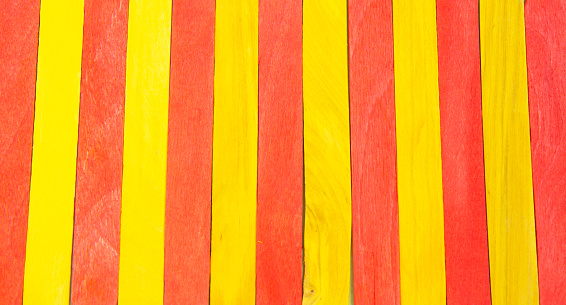 Colorful Ice Cream Stick. Red and yellow color. Abstract wooden sticks background. Colorful rainbow wooden popsicles