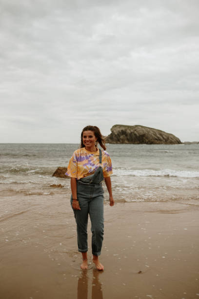 istock Young woman walking and having fun at the beach 1251496396