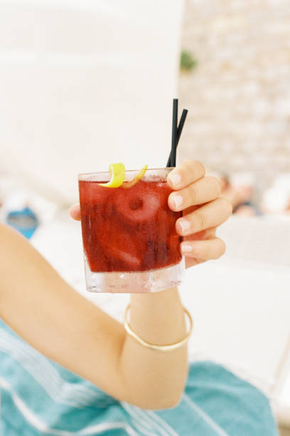 Woman hand holding a Negroni drink