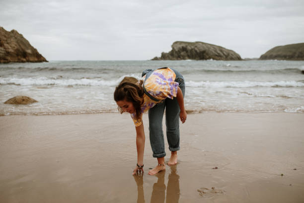 istock Young woman walking and having fun at the beach 1251499704
