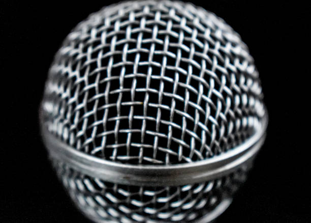 istock Close up image of Dynamic microphone isolated on black background. 1251499954