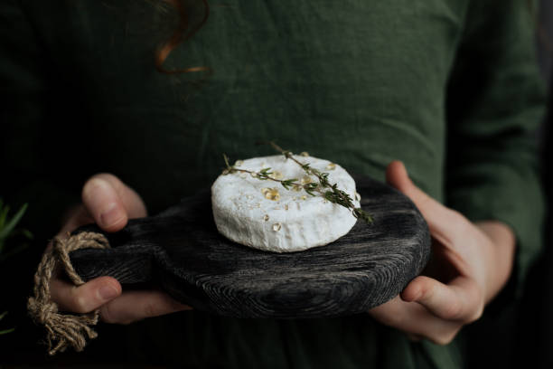 istock Camembert cheese head on a wooden cutting board 1251500551