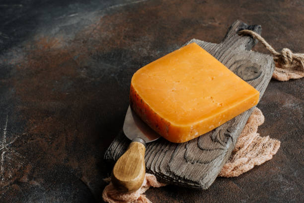istock Cheddar cheese on a wooden board 1251500575