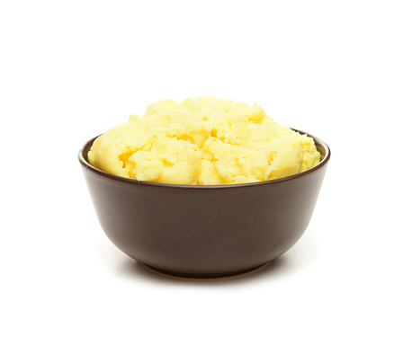 mashed potatoes in a bowl on a white background