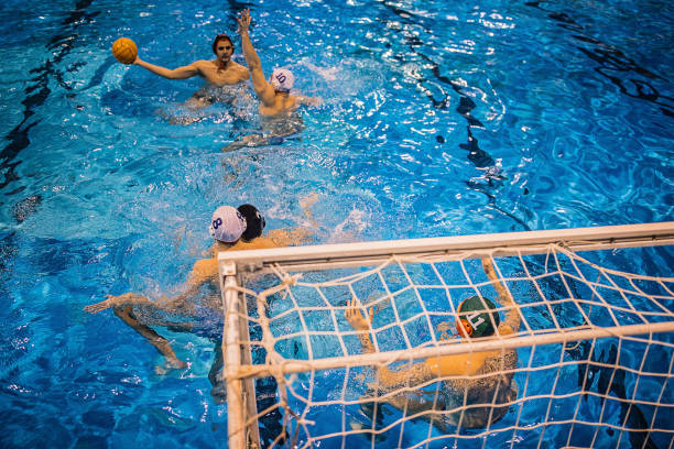 istock Young men playing a water polo game 1251500865