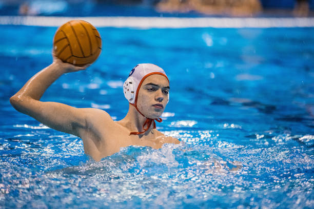 istock Young man playing water polo game 1251502162