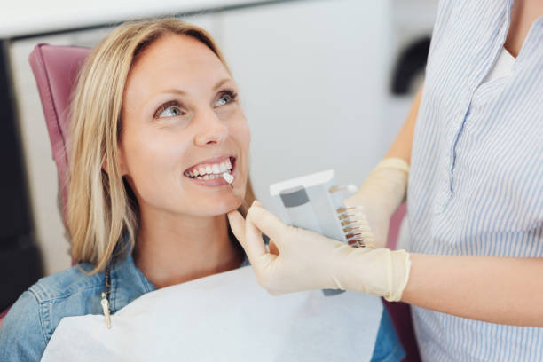 istock Dental nurse doing a color check on a patient 1251502387