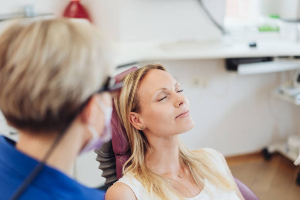 Woman relaxing with her eyes close at the dentist stock photo