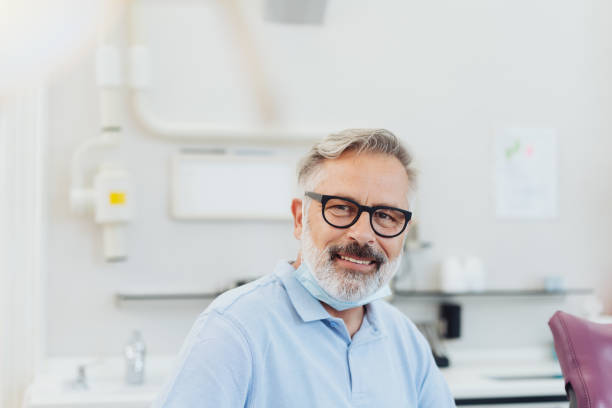 istock Smiling friendly bearded dentist wearing glasses 1251502725