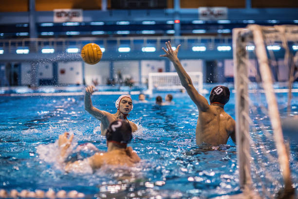 istock Three young men playing a water polo game 1251502726