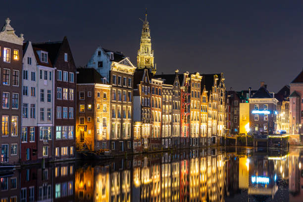 istock Amsterdam Damrak traditional Dutch architecture at night 1251502944