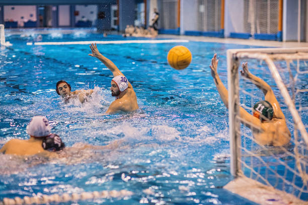 istock Group of men playing a water polo match 1251504568