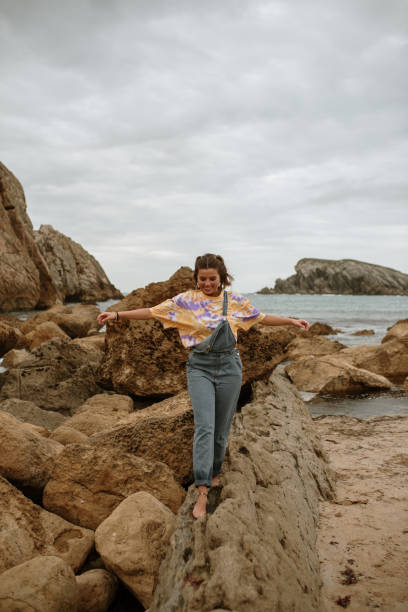 istock Young woman balancing at rocks 1251505977