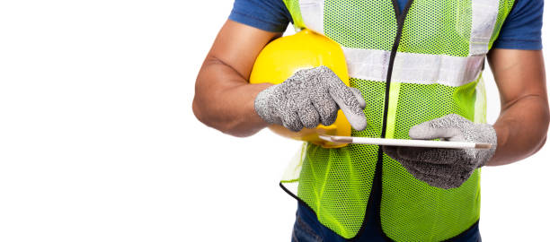 istock Engineer man working on digital tablet computer at worksite or industry. Blue collar worker plan project by use tablet. Handsome young industrial worker hold hard hat, safety glove, reflective vest 1251508266