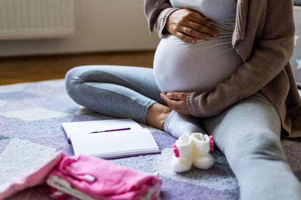 istock Pregnant woman making to do list 1251509248