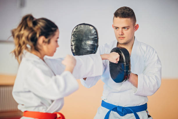 istock Young karate student sparring with her trainer 1251510861