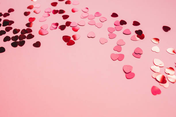 istock Romantic pink backround with red foil hearts 1251513628
