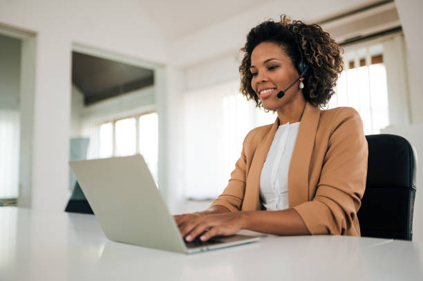 istock Portrait of a beautiful customer support operator with headset working on laptop. 1251514294