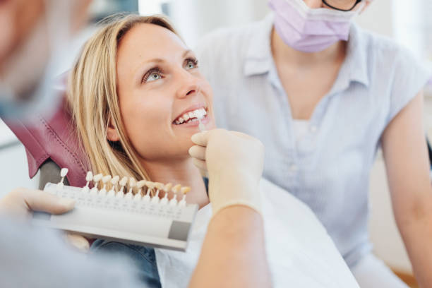 Dentist checking the whiteness of a patients teeth stock photo