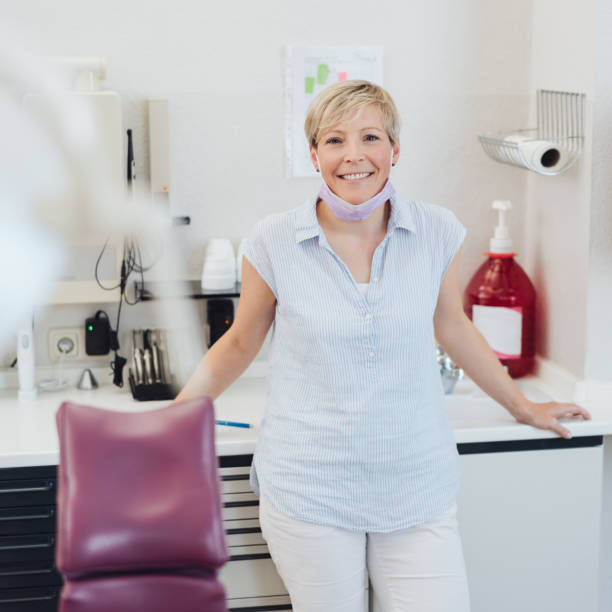 istock Smiling female dentist in her surgery 1251515478