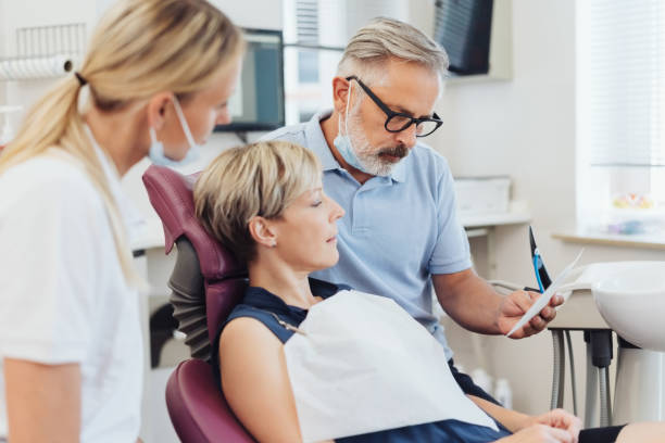 istock Dentist looking at an x-ray with the patient 1251515747