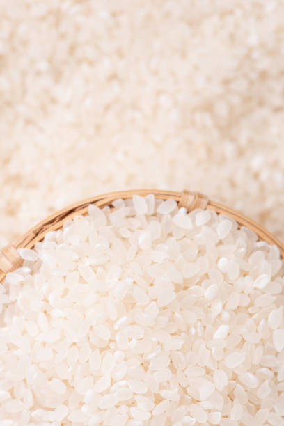 istock Raw rice in a bowl and full frame in the white background table, top view overhead shot. 1251516511