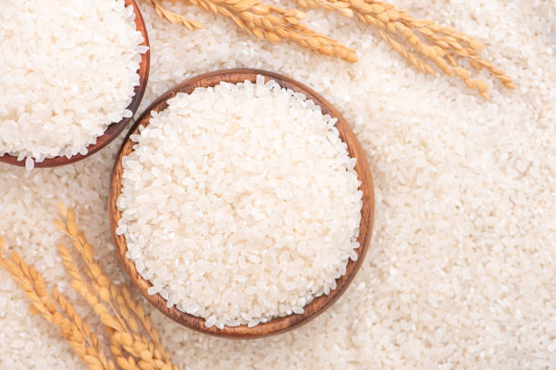istock Raw rice in a bowl and full frame in the white background table, top view overhead shot. 1251516520