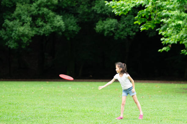 istock Girl playing with flying disc 1251516999