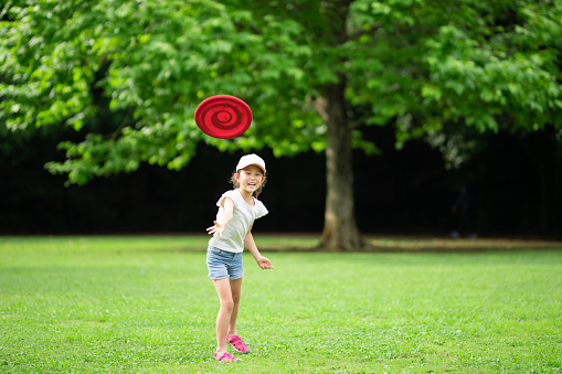 Girl playing with flying disc