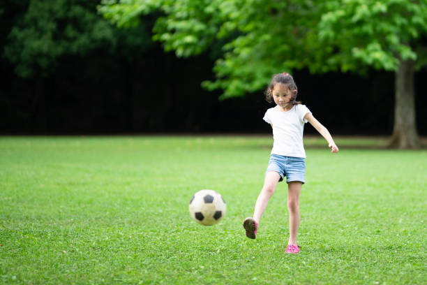 istock Girl playing with a soccer ball 1251517028