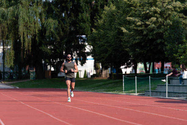 istock Young Man Is Jogging on Sunny Day 1251517409