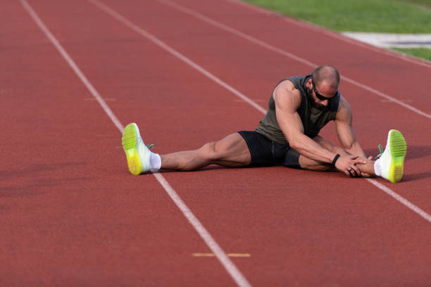istock Handsome Man Stretching Before Exercising Outside Running 1251517515