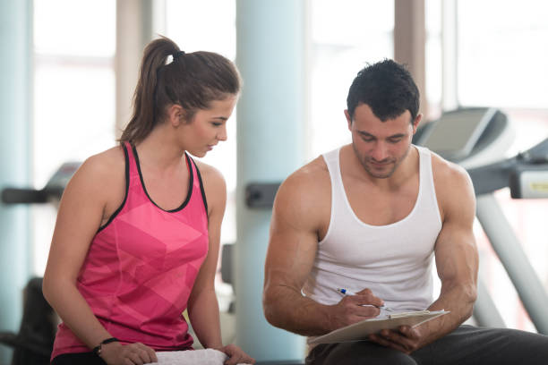 istock Trainer Takes Notes While Woman Sitting and Resting 1251519277
