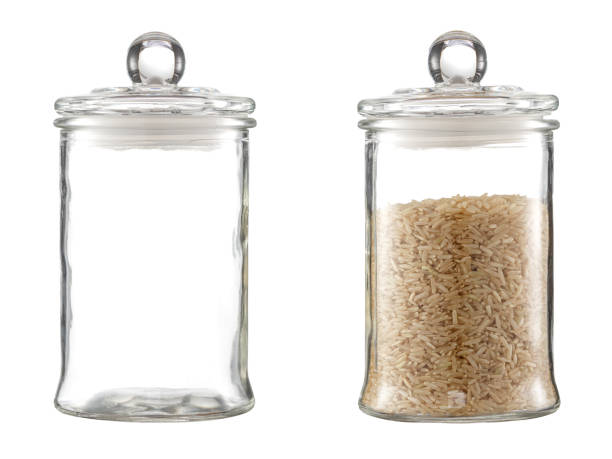 istock Rice in a transparent glass container. Isolated on a white background. 1251520991