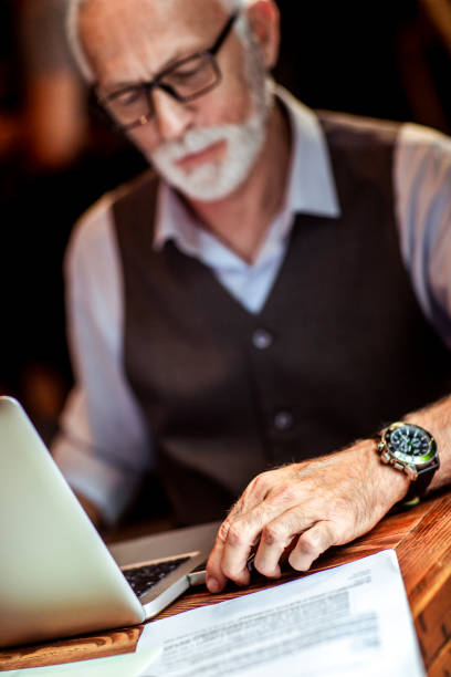 istock A seniorpreneur sticking a usb memory stick into his laptop while working 1251522494