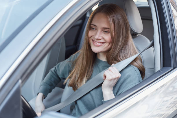 istock Delighted young woman belting up before auto trip 1251522667