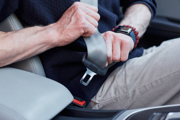 istock Male driver buckling up in his modern auto 1251523414