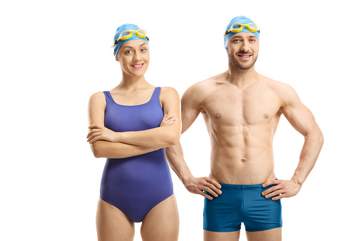 Swimmers in swimming suits, googles and a cap isolated on white background
