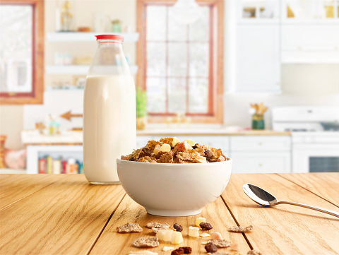 Milk bottle and fruity crispy on the kitchen table.