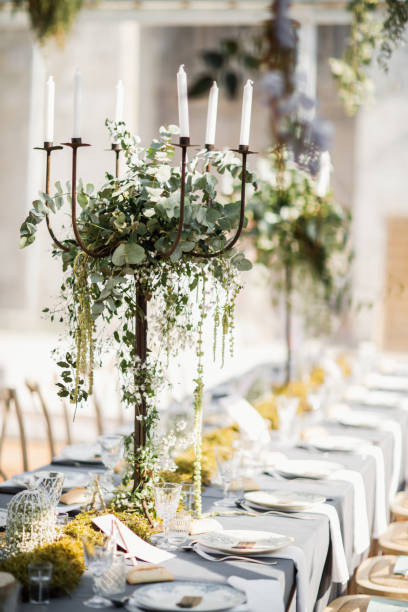 istock wedding table decorated by plates, knives and forks, candle, moss and greenery 1251524960