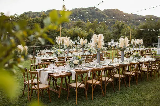 Photo of Wedding table set up in boho style with pampas grass and greenery