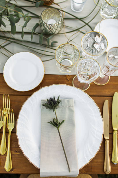 istock Decorated plate with fork and spoon. Table set up in boho style with pampas grass and greenery 1251525041