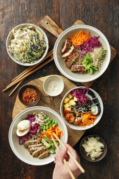 family eating homemade poke bowls and glass noodle salad - prepared shrimp prawn seafood salad imagens e fotografias de stock