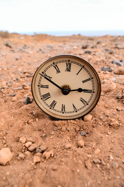 istock Classic Analog Clock In The Sand 1251526487